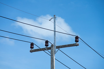 electric wire  on electrical pole with blue cloudy sky background