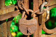 Old Rusty Lock On The Gate Close-up . Rusty Chains