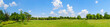 panorama of green lawn field with trees in the background. Park at Mogosoaia Palace near Bucharest, Romania.