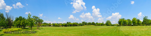 Plakat panorama of green lawn field with trees in the background. Park at Mogosoaia Palace near Bucharest, Romania.