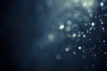 bokeh of water fly and lights on black background,