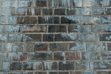 Old gray vintage weathered brick wall texture of ancient castle. Grunge rough block stonewall, masonry structure surface pattern as wallpaper or backdrop for design with copy space