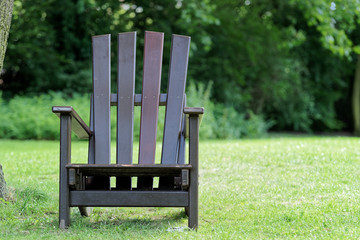 Wooden chair for relaxing on the green meadow