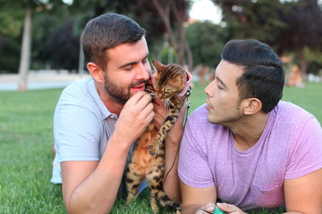 Wall Mural - Gay couple in the park with their pet