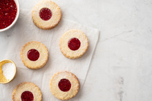 Christmas Cookies. Linzer Cookies With Raspberry Jam On White Table Background. Traditional Austrian Biscuits Filled. Top View And Copy Space