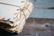 © Alexandra - Stack of vintage letters on wooden table