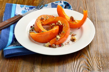 Wall Mural - Slices of pumpkin baked in the oven with walnuts and spices