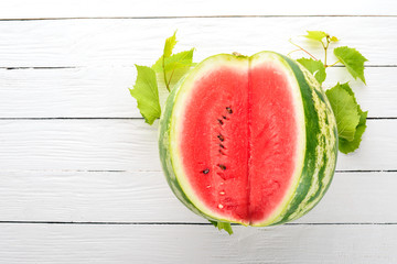 Fresh ripe watermelon. Melon. On a white wooden background. Free space for text. Top view.