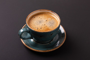 Cup of coffee on black background. Copy space. Top view. Flat lay.