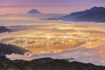 Peak of Mount Fuji And the sea of mist over Lake Suwa in autumn morning