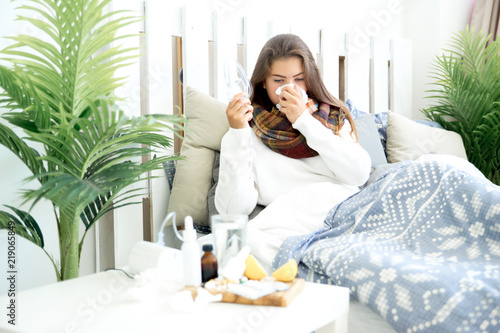 Stampa su Tela ill young girl with fever spending time at home