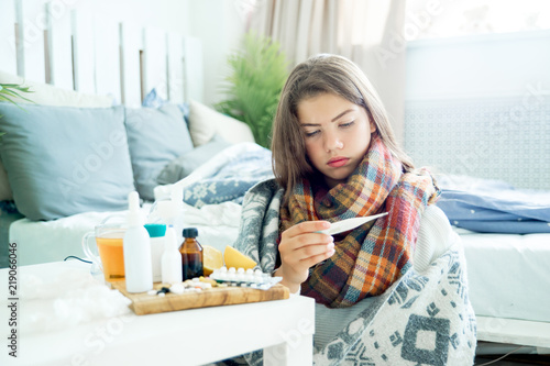 Fotomural ill young girl with fever spending time at home