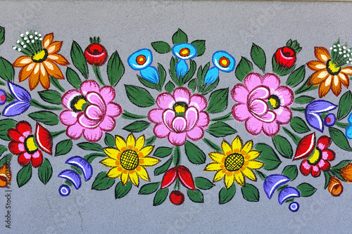 Fotografering Painted beautiful floral pattern on the facade of an old house, folk art, Zalipie, Poland
