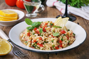 Wall Mural - Salad with bulgur, tomatoes, cucumbers and fresh herbs