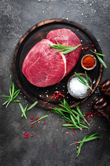 Canvas Print - Raw beef meat. Fresh cut of beef meat on board with spices