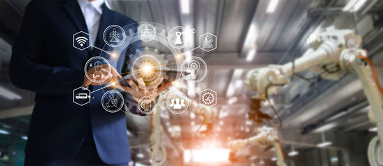 Fototapete - Industry, 4.0 concept, Industrial engineer manager using tablet checking and controlling automation robot arms machine in intelligent factory on system software. 