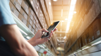 Poster - Factory worker using application on mobile smartphone to operate automation for modern trade. Checking order in large warehouse. Import and export the shipping cargo. Business marketing and technology