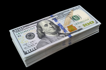 Wall Mural - Stack of one hundred dollar bills isolated on black background. Stack of cash money in hundred dollar banknotes. Heap of hundred dollar bills background. Concept of financial success.