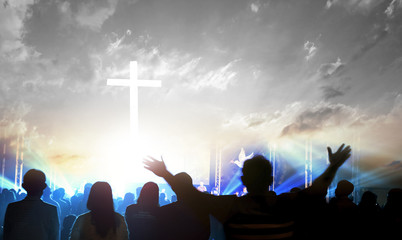 Wall Mural - worship and praise concept: silhouette many people raised hands over sunset background