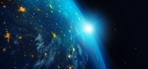 Wall Mural - earth from space at night with city lights and blue sunrise on stars background. 3d rendering.