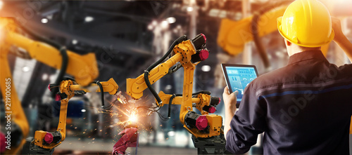 Cuadros en Lienzo Engineer check and control welding robotics automatic arms machine in intelligent factory automotive industrial with monitoring system software