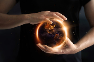Wall Mural - hands holding global showing the world' s energy consumption at night, environment and energy conser