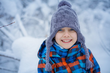 Beautiful young boy in winter park