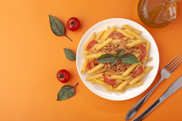 Poster - Pasta Fettuccine Bolognese with tomato sauce and basil in white dish on the orange background.