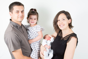 Wall Mural - happy family of four with two children baby son and daughter on white background