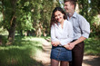 © soleg - young couple walking in the forest, summer nature, bright sunlight, shadows and green leaves, romantic feelings