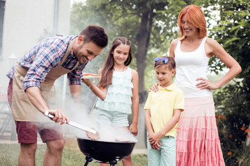 Wall Mural - Family on vacation having barbecue