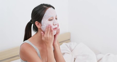 Wall Mural - Woman apply paper mask at home