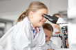 © Syda Productions - education, science and children concept - kids or students with microscope studying biology at school laboratory