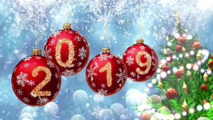 Wall Mural - red balls with numbers 2019 hanging on the background of a blue bokeh and a rotating christmas tree 