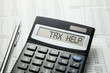 © adragan - Tax help. On display of calculator is written tax help