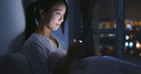 Poster - Woman use of mobile phone at home in the evening