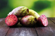 © beats_ - Fruits of the prickly pear cactus on a rustic table.