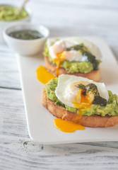 Wall Mural - Sandwiches with guacamole and poached eggs