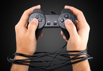 Wired hands with joypad meaning videogame addiction