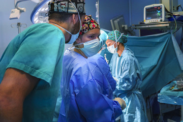 Surgical assistant informing the nurse in the ear