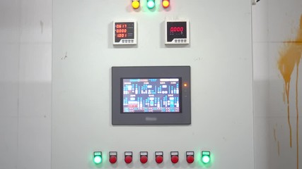 Control screen and status lights and buttons. Touchscreen interface on monitoring equipment. Industrial equipment screen and blinking lights for status and modification.