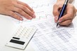 © BillionPhotos.com - Close-up of a Businessman Analyzing Business Graphs