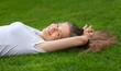 Portrait of a Young Woman Lying Down on the Grass