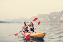 Couple Paddling In A Canoe