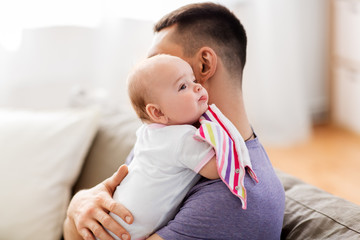 family, parenthood and people concept - father with little baby girl at home