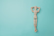Wooden puppet points aside with its hand. Conceptual image about relax time. Minimal style.