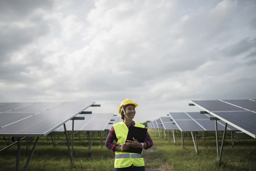 Engineer electric woman checking and maintenance of solar cells.