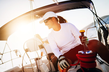 Wall Mural - Attractive strong woman sailing with her boat