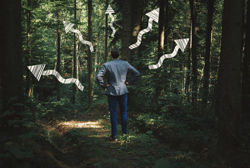 Casual business man facing a challenge and options. Thinking what path to take. Business vision and options