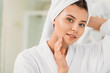 © LIGHTFIELD STUDIOS - beautiful smiling girl in bathrobe and towel on head looking at camera in bathroom